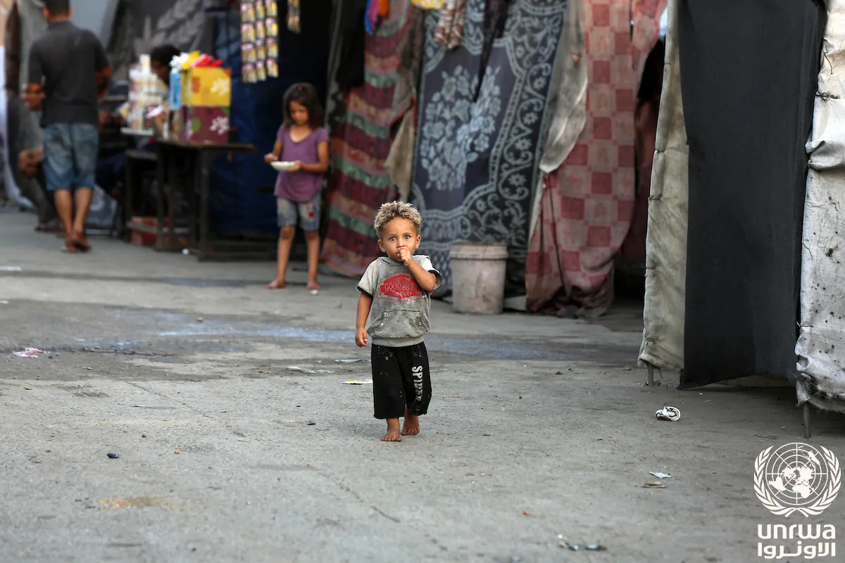 Displaced child stand in front of his tent at a shelter after Israeli army orders to evacuate east of Deir el-Balah, Gaza Strip
