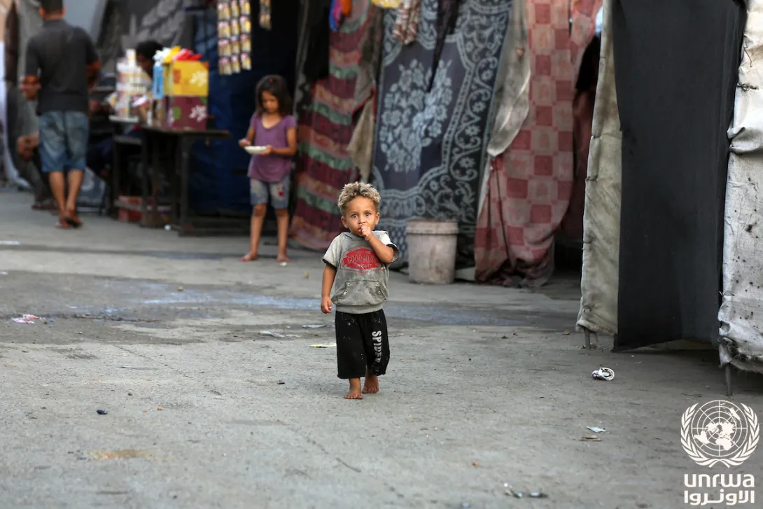 Displaced child stand in front of his tent at a shelter after Israeli army orders to evacuate east of Deir el-Balah, Gaza Strip